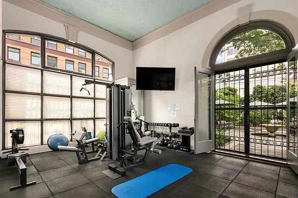 a view of a livingroom with workspace and a window