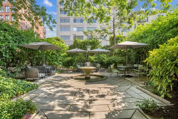 a view of a house with backyard fountain and sitting area