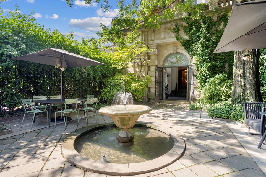 240 Centre Street, Unit 5B Manhattan, NY 10013 - Photo 34 of 37 a view of a house with backyard fountain and sitting area