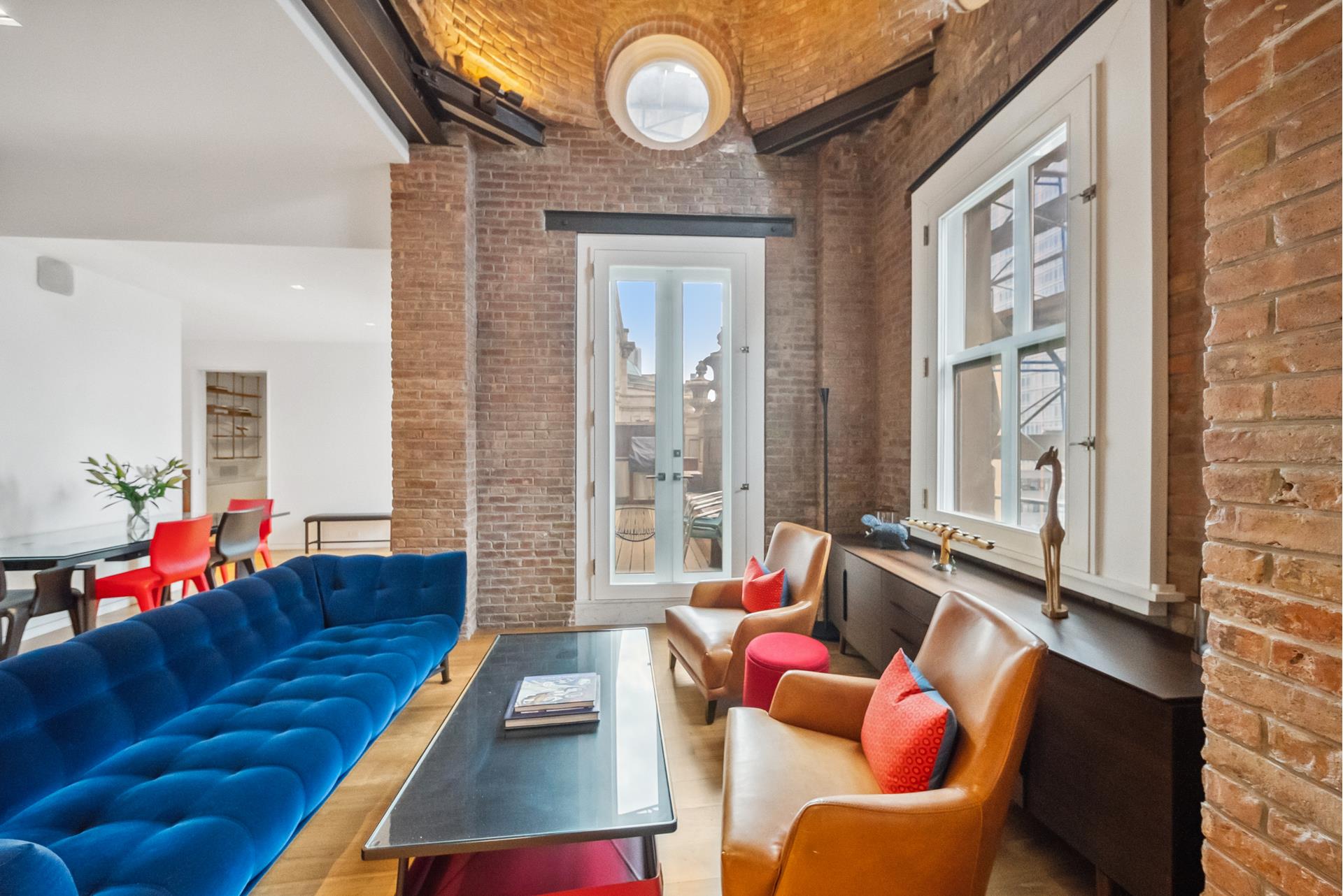 240 Centre Street, Unit 5B Manhattan, NY 10013 - Photo 5 of 37 a living room with furniture and a large window