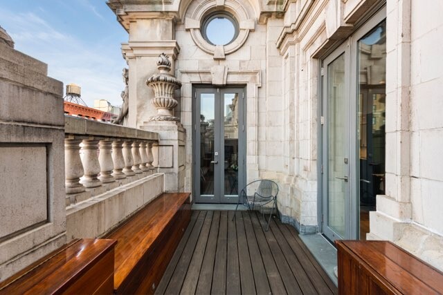 240 Centre Street, Unit 5B Manhattan, NY 10013 - Photo 6 of 37 a view of a balcony with wooden floor and iron stairs