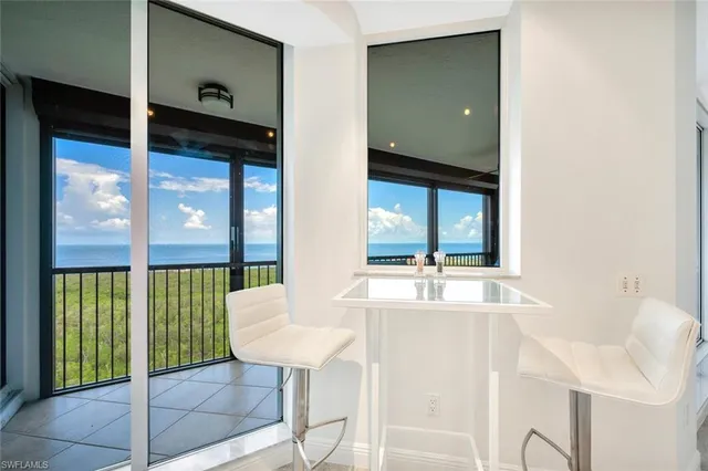 a room with a table and a refrigerator