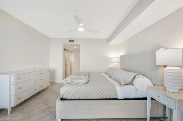 a bedroom with a bed and a night lamp