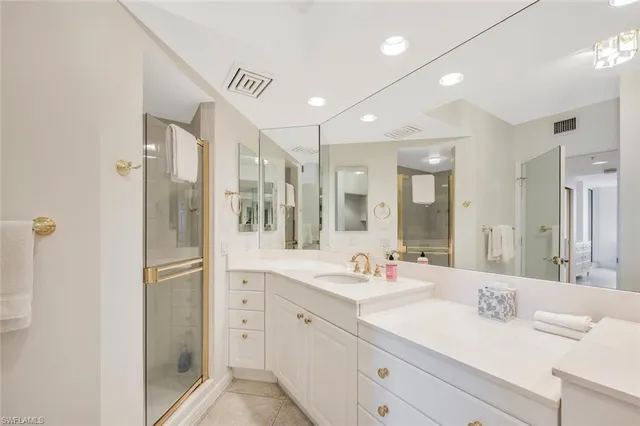 a spacious bathroom with a shower sink double and mirror
