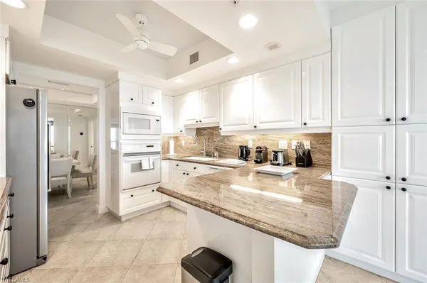 a kitchen with stainless steel appliances granite countertop a refrigerator sink and cabinets