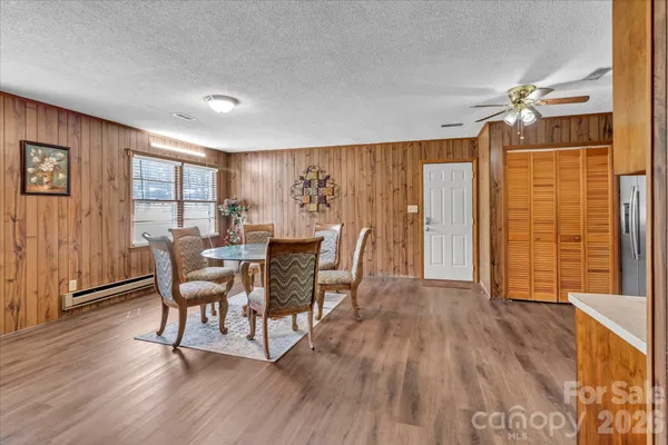 a dining room with furniture and wooden floor