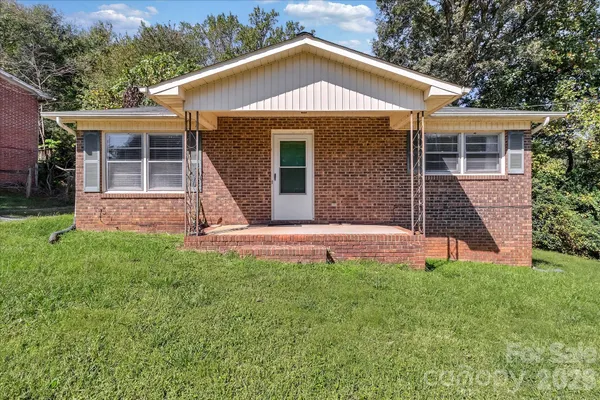 a front view of a house with a yard and porch
