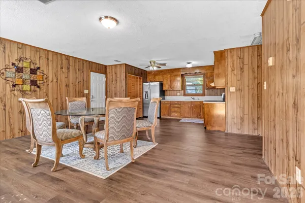 a dining room with furniture and wooden floor