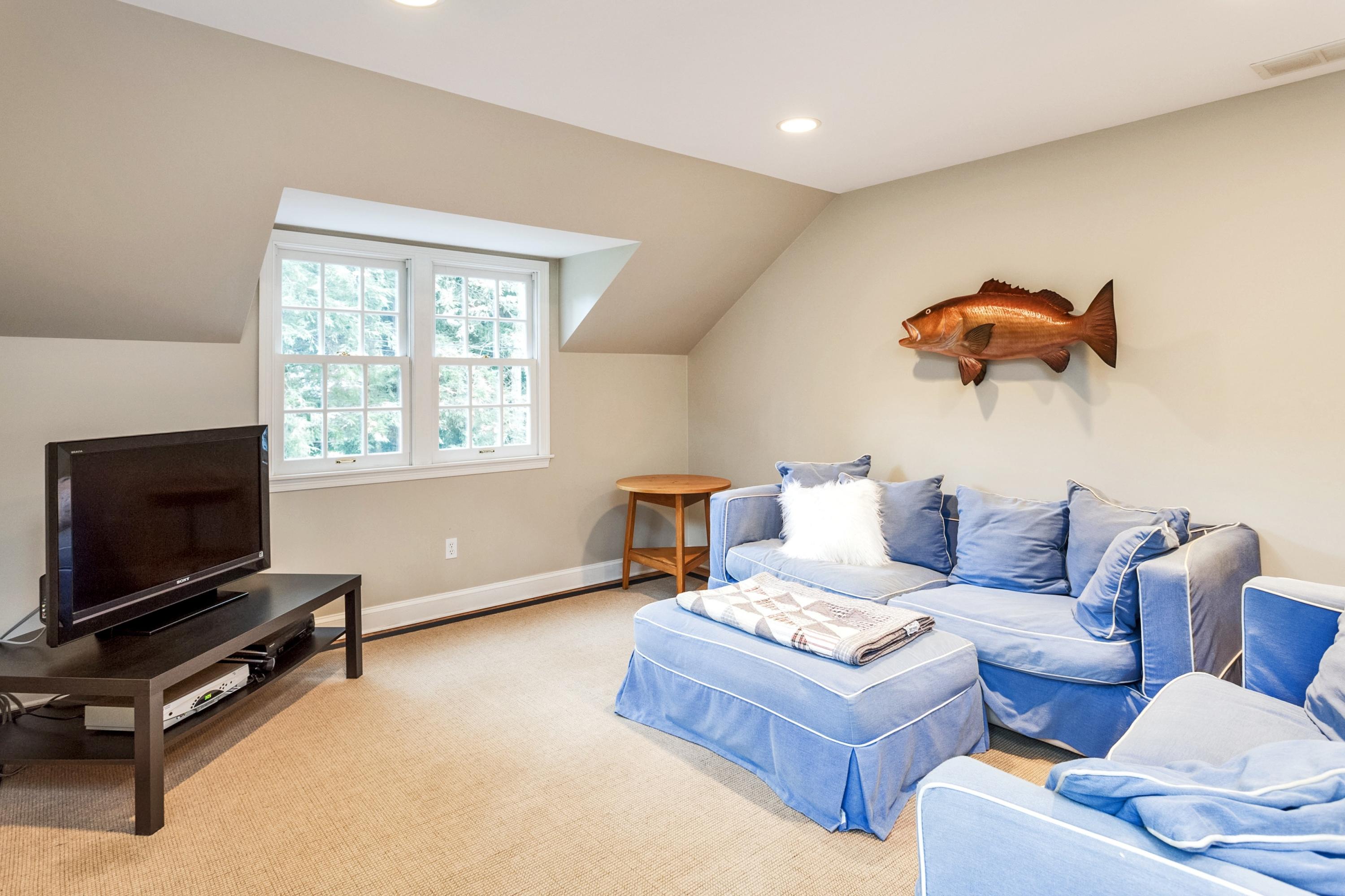 11 Deepwood Road Darien, CT 06820 - Photo 31 of 34 a living room with furniture a flat screen tv and a window