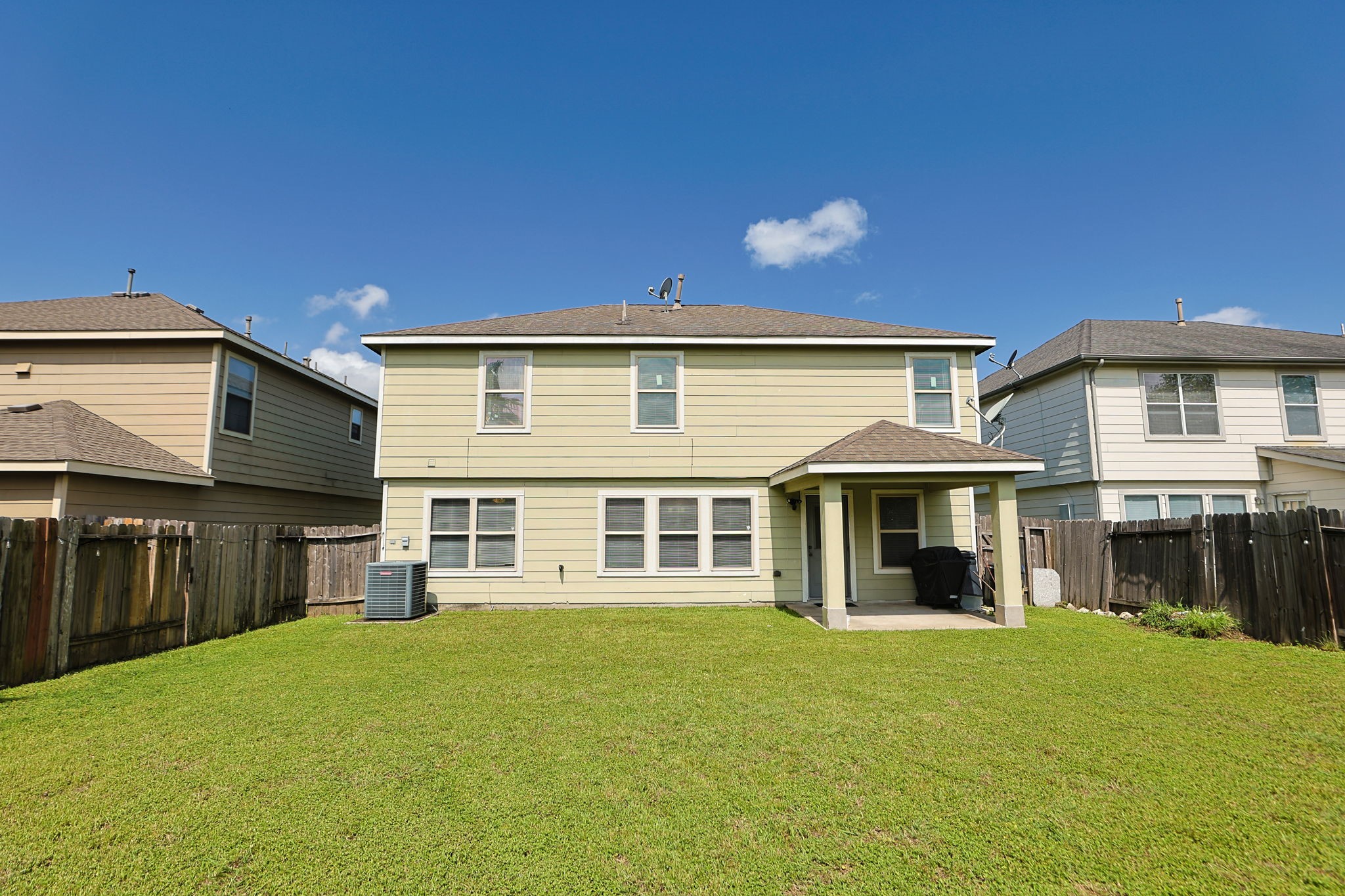 11642 Quinn Ridge Way Houston, TX 77038 - Photo 21 of 22 Back of the home with a large back yard and covered patio