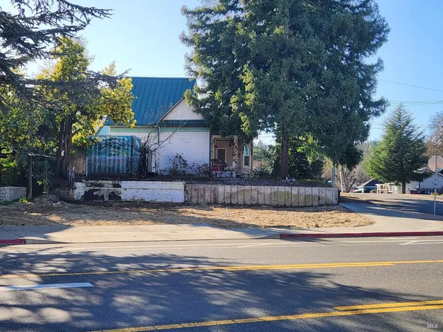 a view of a house with pool and a yard