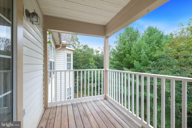 a view of a balcony with wooden floor