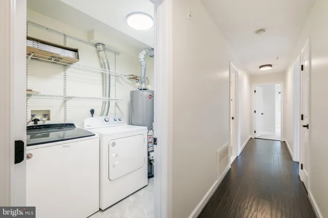 a view of a kitchen with refrigerator and wooden floor