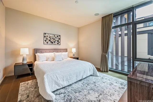 a bedroom with a bed a dresser and book shelf