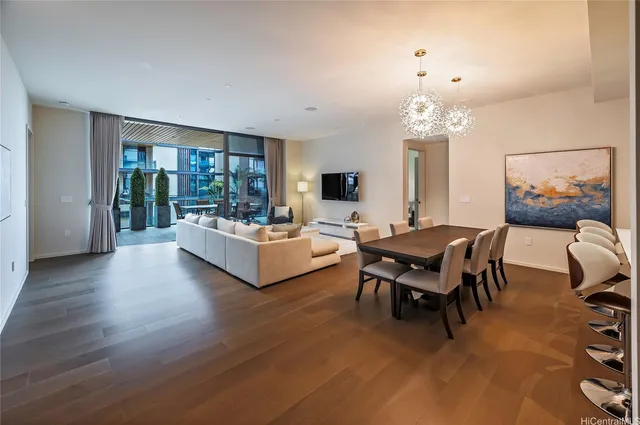 a living room with furniture and a chandelier