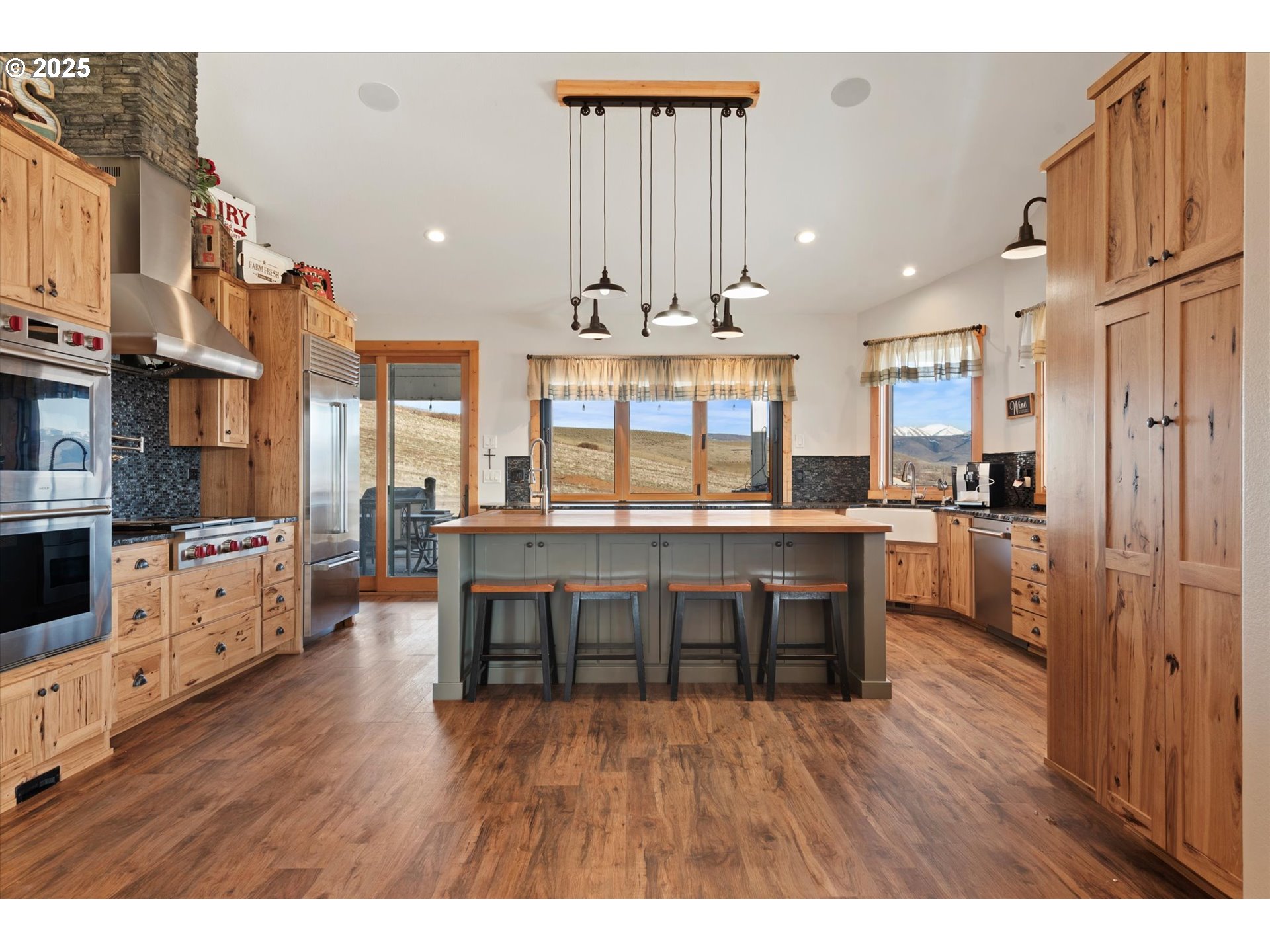 42759 Moody Road Richland, OR 97870 - Photo 6 of 27 a kitchen with stainless steel appliances a dining table chairs stove refrigerator and cabinets