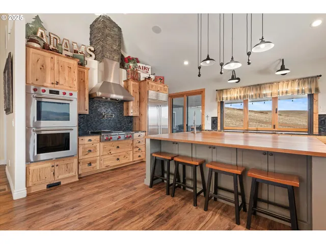 a kitchen with stainless steel appliances granite countertop a stove and cabinets