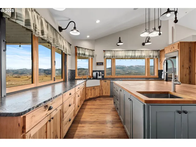 a kitchen with granite countertop a sink and a large window