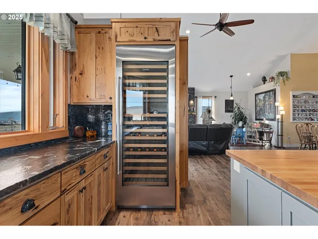 a kitchen view with granite countertop a sink stainless steel appliances and cabinets