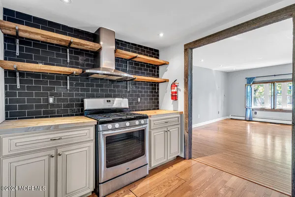 a kitchen with granite countertop a stove and a sink