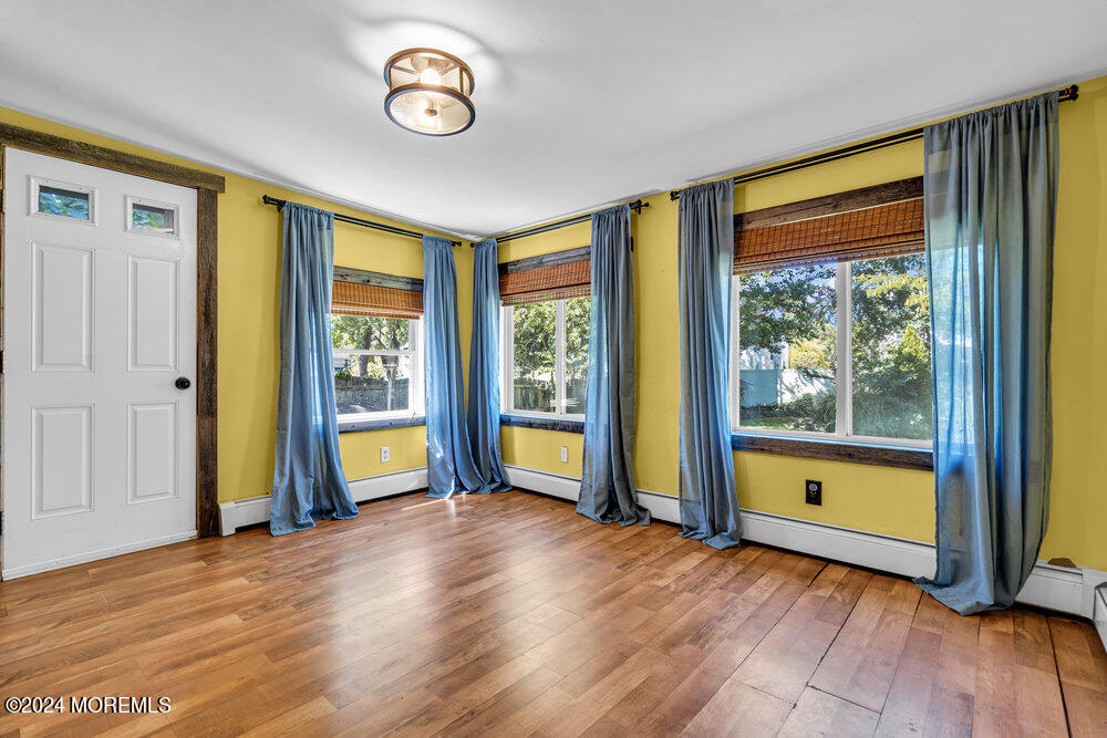 105 Longfellow Avenue Toms River, NJ 08753 - Photo 15 of 38 a view of an empty room with wooden floor and a window