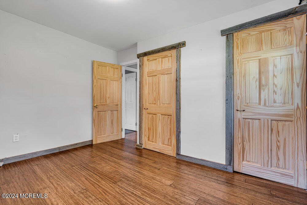 105 Longfellow Avenue Toms River, NJ 08753 - Photo 20 of 38 an empty room with wooden floor and windows