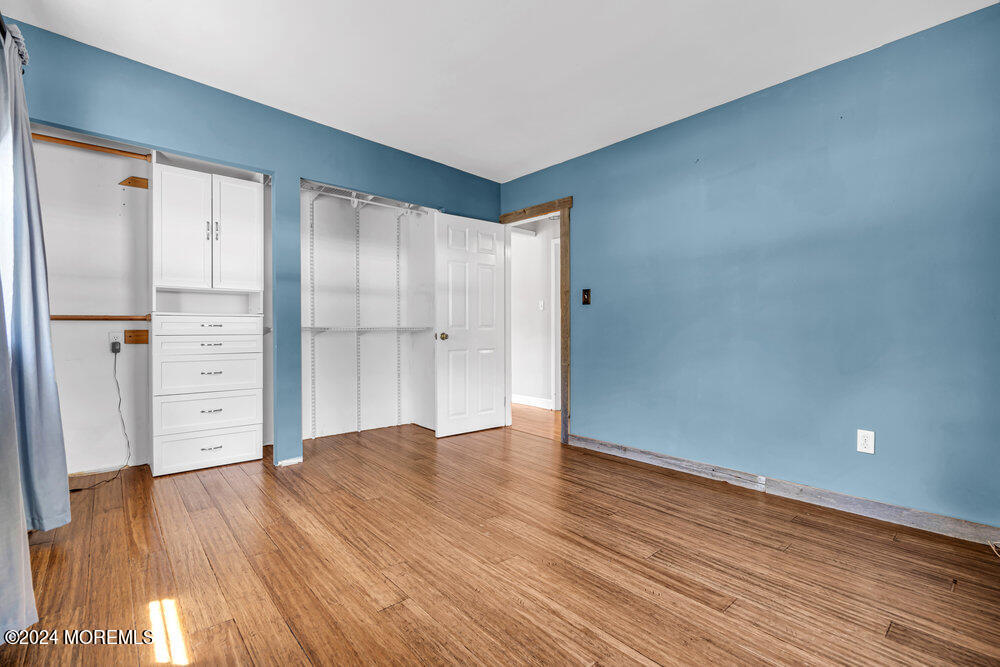 105 Longfellow Avenue Toms River, NJ 08753 - Photo 22 of 38 an empty room with wooden floor and closet area