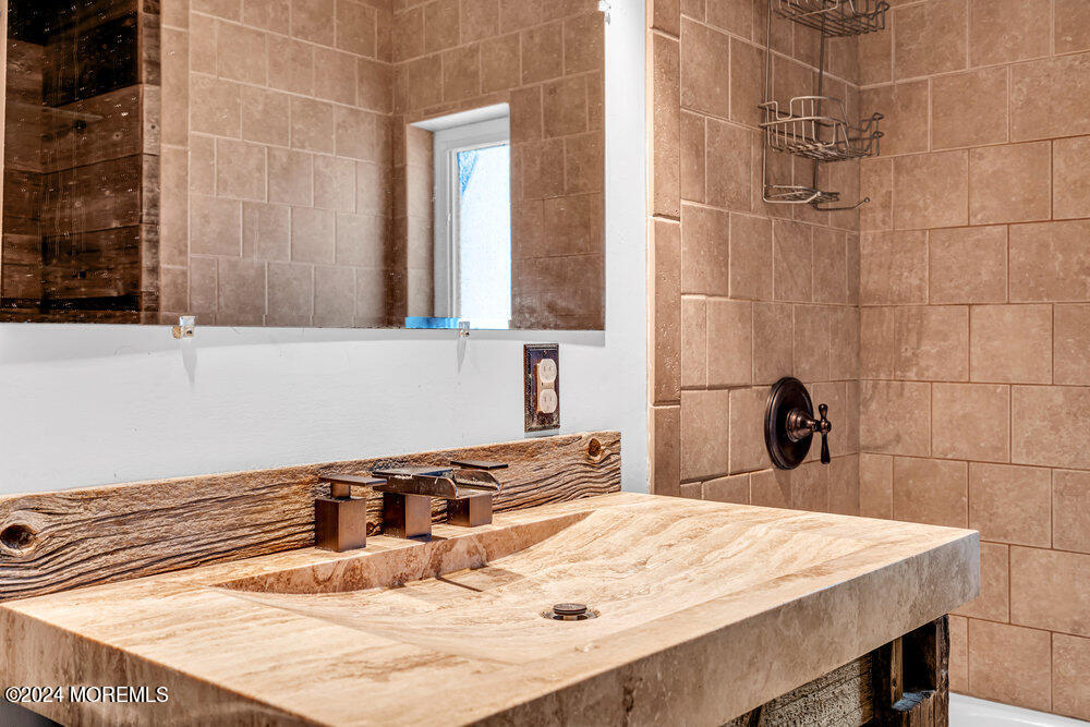 105 Longfellow Avenue Toms River, NJ 08753 - Photo 25 of 38 a bathroom with a sink and a mirror