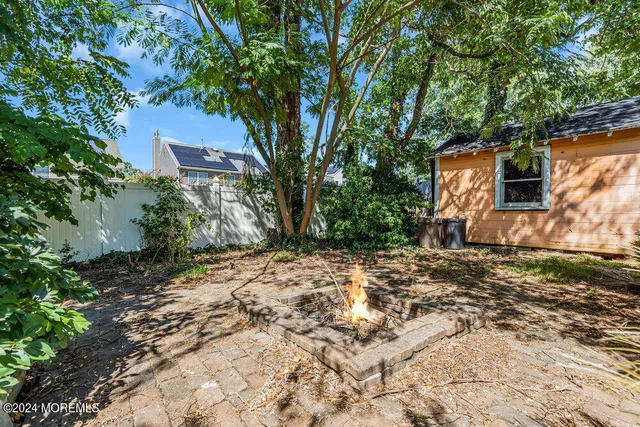 a backyard of a house with plants and trees