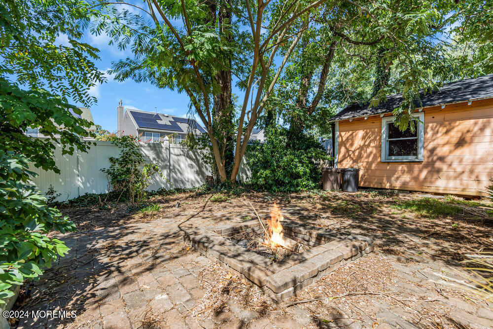 105 Longfellow Avenue Toms River, NJ 08753 - Photo 31 of 38 a backyard of a house with plants and trees