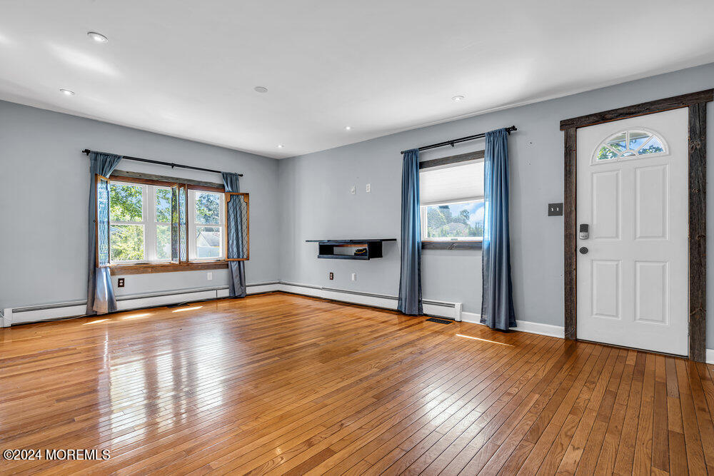105 Longfellow Avenue Toms River, NJ 08753 - Photo 8 of 38 a view of an empty room with wooden floor and a window