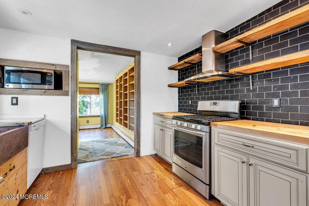 105 Longfellow Avenue Toms River, NJ 08753 - Photo 10 of 38 a kitchen with stainless steel appliances granite countertop a stove and a microwave
