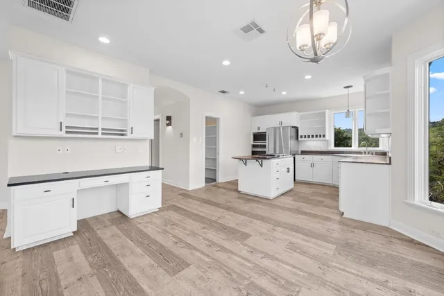 a view of an empty room with glass door and balcony