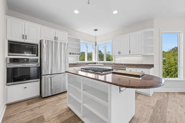 a kitchen with granite countertop a sink stove and cabinets