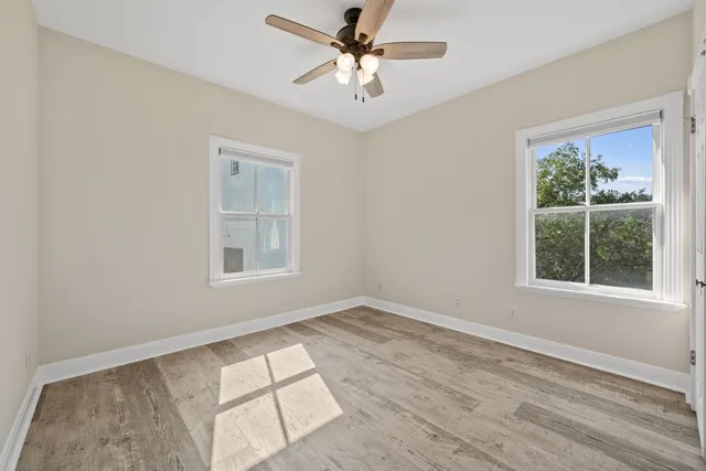a bathroom with a granite countertop sink a toilet and a mirror