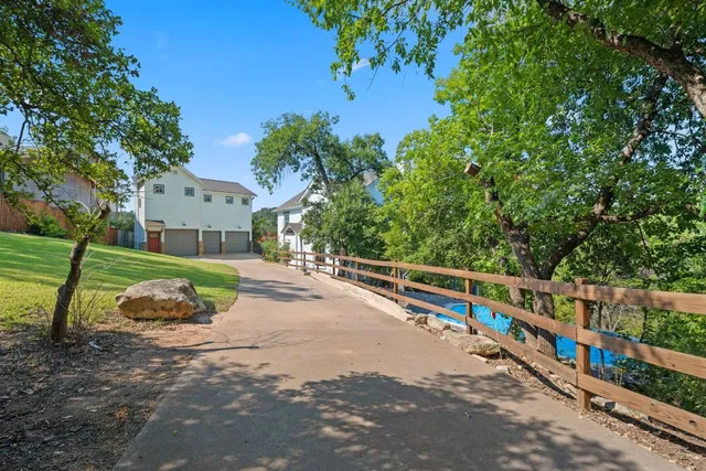 a front view of a house with a yard and trees