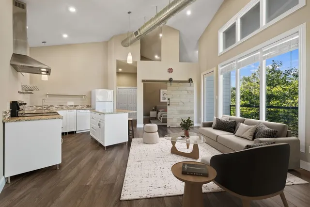 a bedroom with a large bed and paintings on the wall