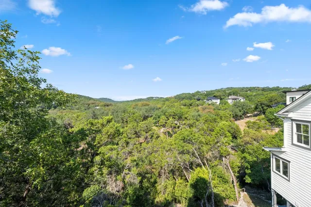 an aerial view of a house with swimming pool and garden space