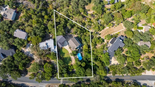 a aerial view of a house with swimming pool and garden
