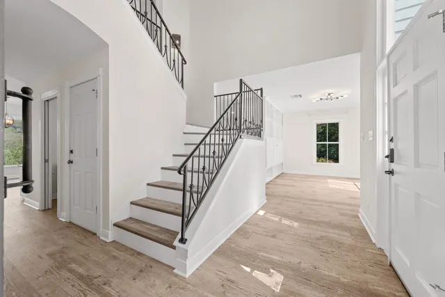 a view of entryway and hall with wooden floor
