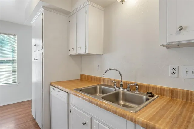 a kitchen with kitchen island a sink and cabinets