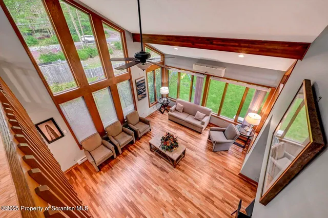 a living room with furniture and large windows