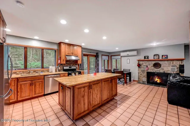 a living room with fireplace furniture and a flat screen tv