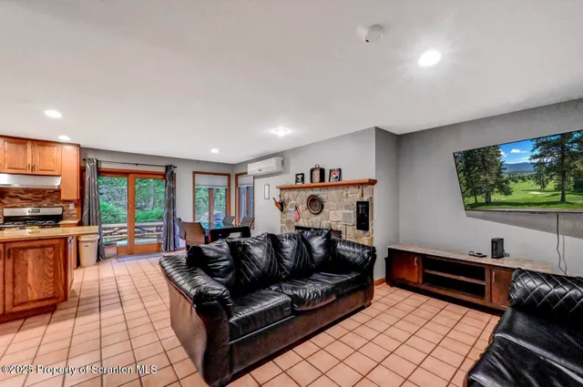 a living room with furniture and a floor to ceiling window