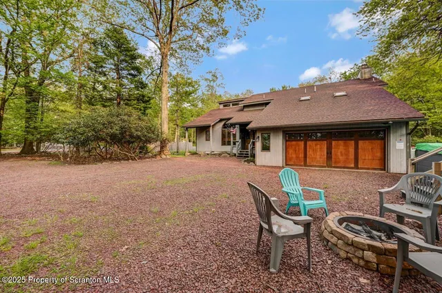 a patio with sofas fire pit table and chairs