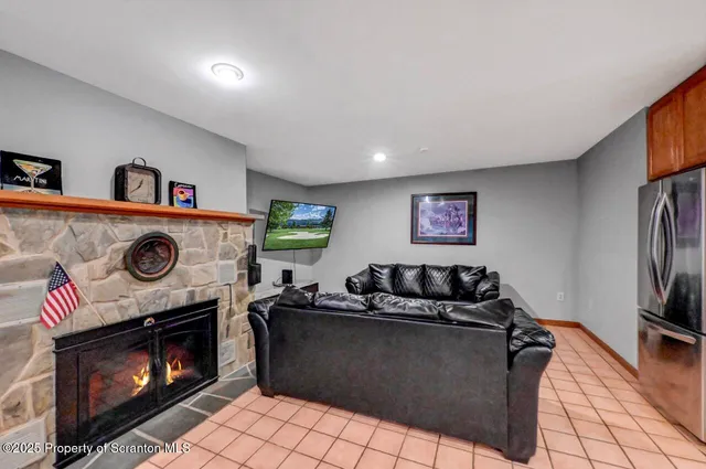 a large bedroom with a bed and wooden floor