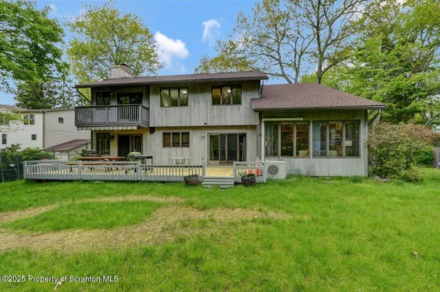 a view of a house with a backyard and a slide