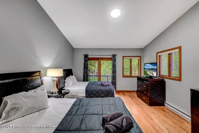 a view of a two chairs and table on the wooden deck