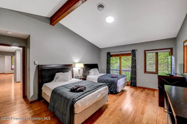 a view of an house with backyard and a tree