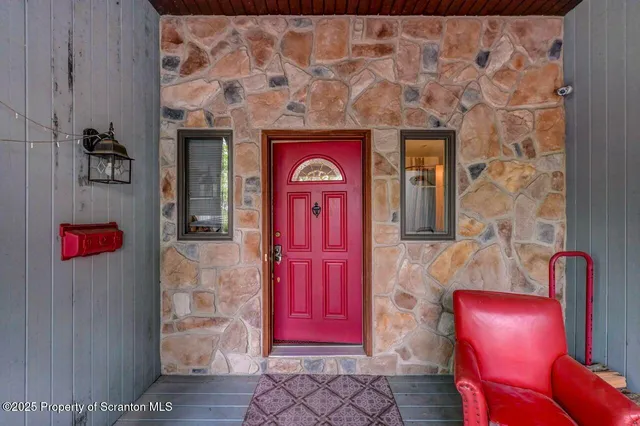 a living room with furniture and floor to ceiling windows